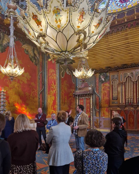 A group of delegates with Dan Cox in the Music Room at the Royal Pavilion