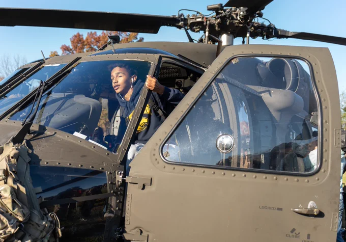 A student climbs into a Black Hawk helicopter.