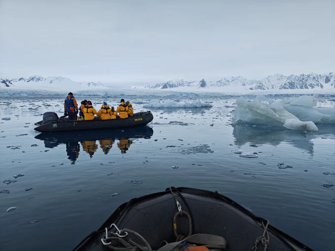 Image of people traveling by boat in Arctic climate 