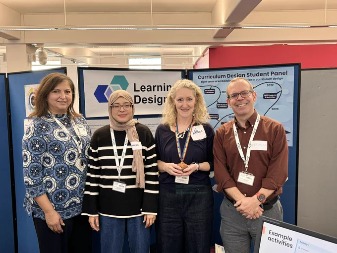 4 members of the OU_LD team posing in front of one of the #LearningDesign stands.