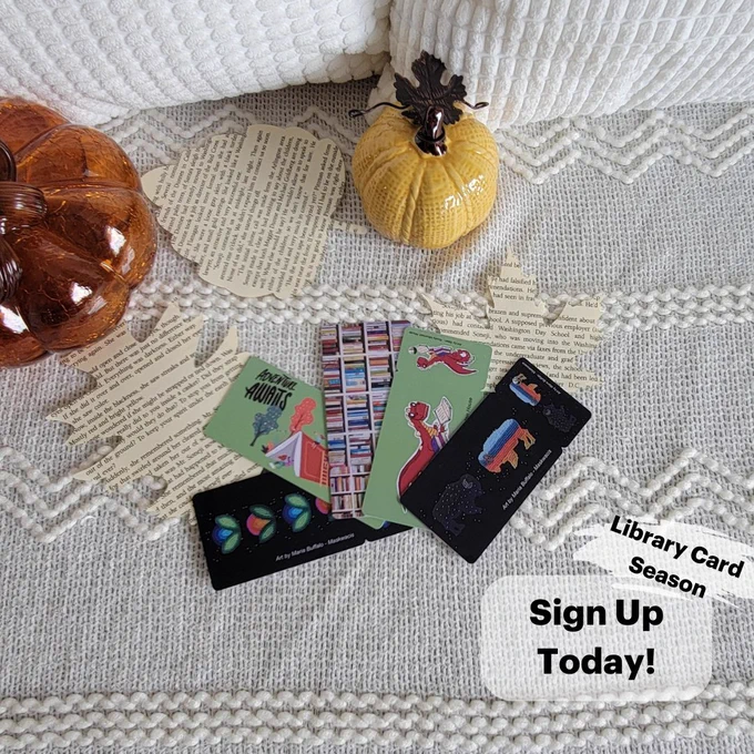5 library cards on blanket with leaves and pumpkins
Text: Library Card Season. Sign Up today!