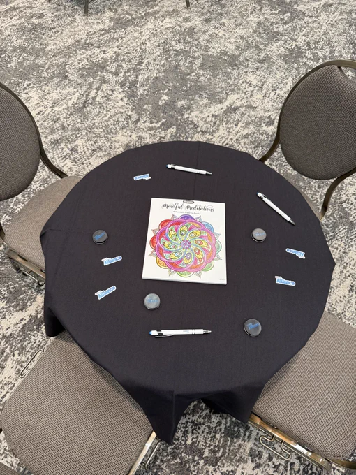 A table with a coloring book and giveaways