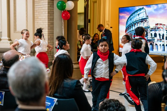 This photo shows a group of young students dancing and dressed up in honor of Italian Heritage month.