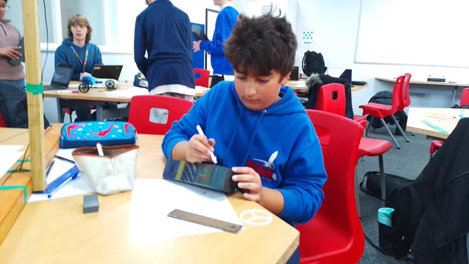 Student decorating a rocket car