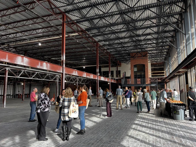 A look inside the planned site of the Green Bay Public Market. Celebrants gather around tables after the market’s groundbreaking ceremony. 