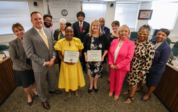 This is a group photo of State Board Members and Dr. Wright smiling with the MASSP 2024 Principal and Assistant Principal of the Year, who are holding certificates.