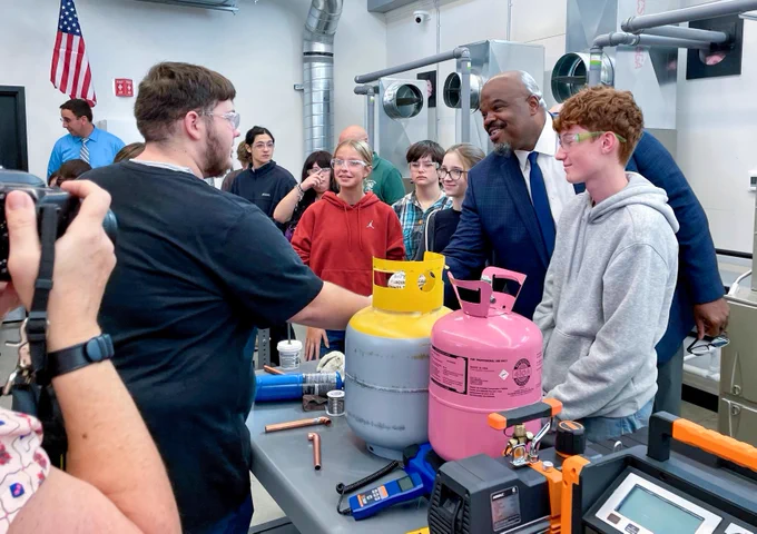 Education Secretary Patrick Tutwiler visits with McCann Technical High School students and shakes one student's hand.