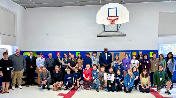 Education Secretary Patrick Tutwiler takes a group photo with Clarksburg Elementary School students and staff.