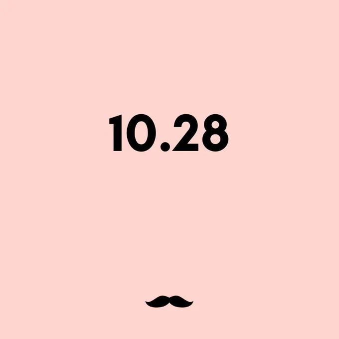 A light pink square with the date "10.28" written on it. A small mustache is at the bottom of the image.