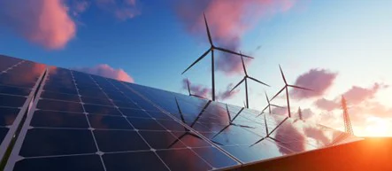 Image of wind turbines and solar panels at sunset. Source: greensync.com