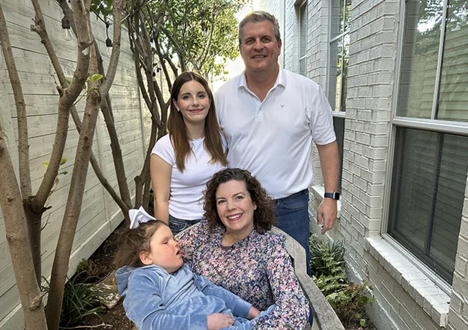 Brian and Julia Broadbent are raising their daughters Claire, top left, and Emma, seated.