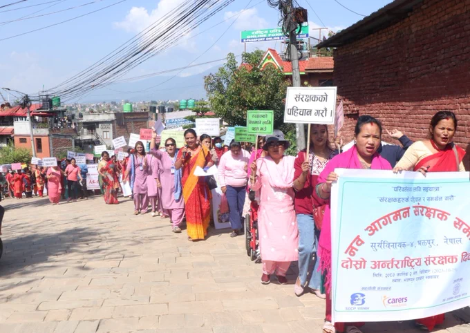 Large group of people holding a rally in the street

