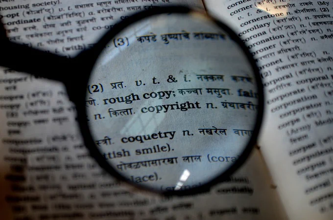 A magnifier hovers over a dictionary entry for "Copyright" 