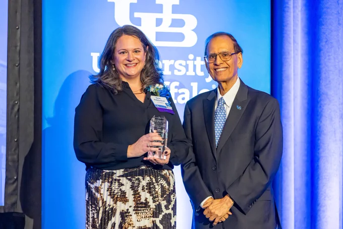Karen Andolina Scott accepts the Walter P. Cooke Community Leadership Award from UB President Satish K. Tripathi.