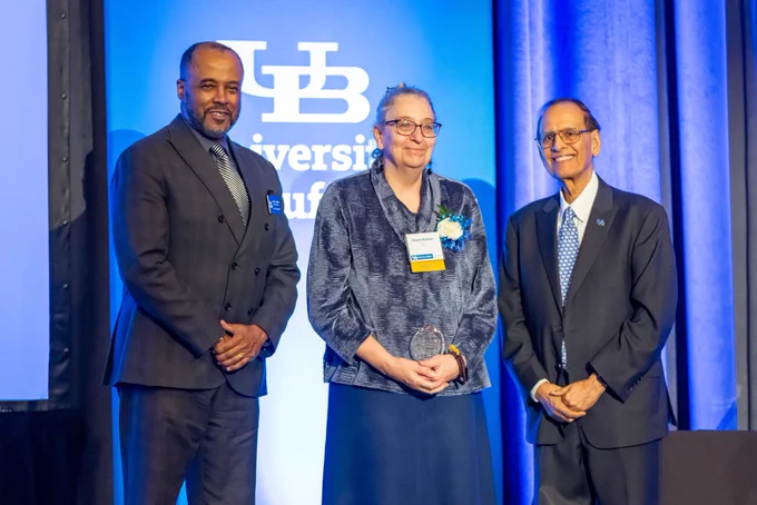 Distinguished Alumni Award recipient Deana Bodnar, with Keith A. Alford, dean of the School of Social Work, and UB President Satish K. Tripathi.
