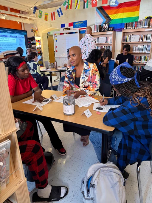 Rep. Ayanna Pressley joins students at a table for Civic Leaders Tutoring Week.
