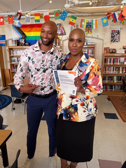 Rep. Ayanna Pressley receives a certificate for participating in Civic Leaders Tutoring Week.