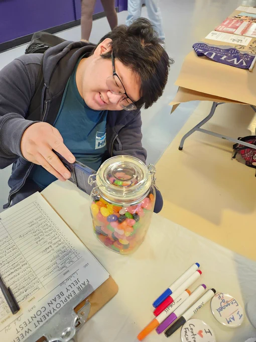 A student counting jellybeans in a jar. 