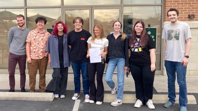 Eight SBWU members pose and celebrate after their election win!