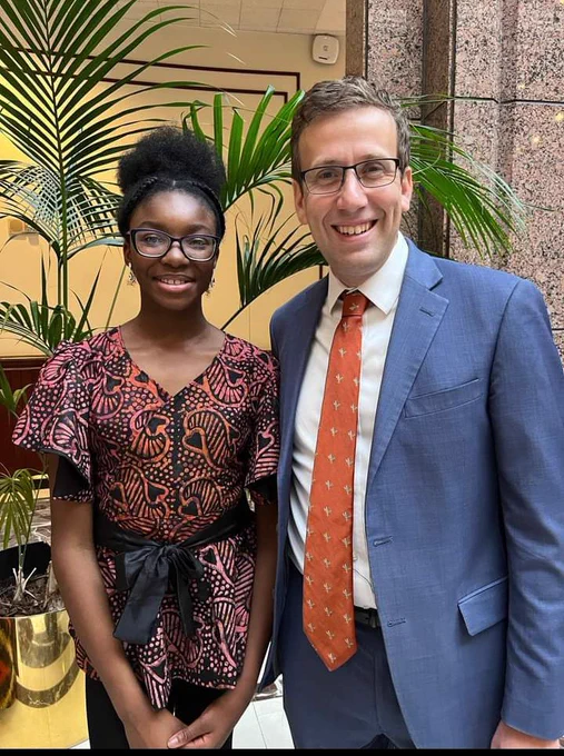 Photo of student Eniola Shokunbi & State Senator Matt Lesser (D), standing in the legislative office building at the state capitol.
