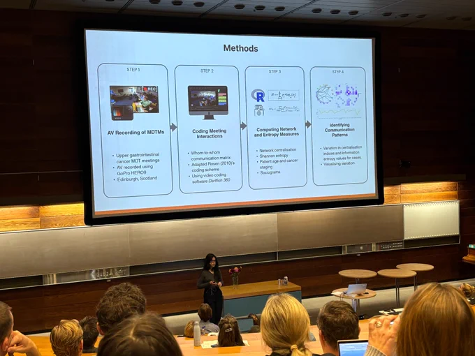 A PhD candidate presenting research