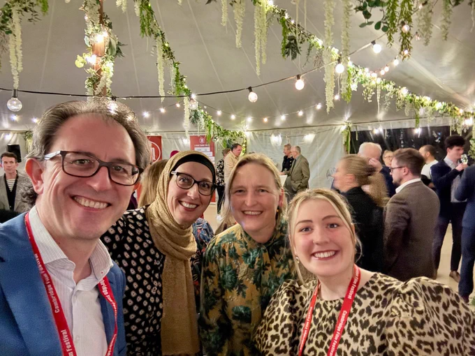 Simon, Zuzana and Kate from Studio 24 with Abby from the Film Festival in a marquee adorned with fairy lights and foiliage.