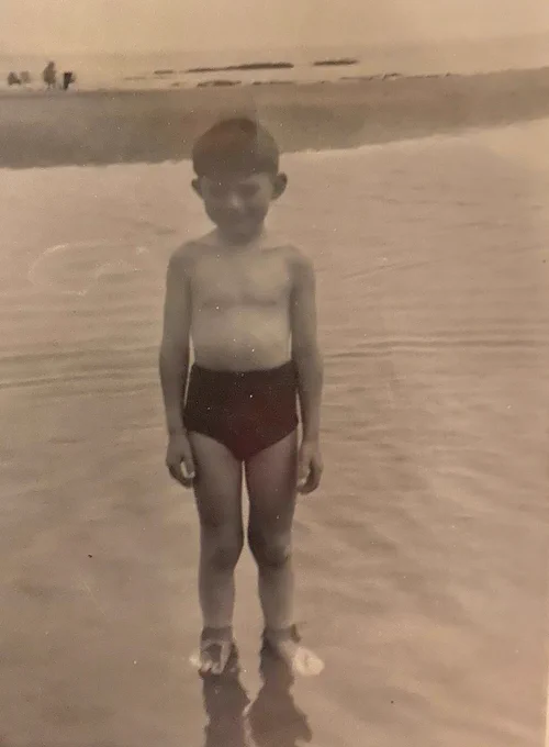 Sepia photograph of a young boy (Andy) in swimming trunks
