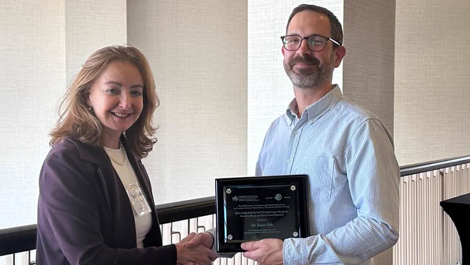 Image of Dr. Jason Fish (right) receiving an award.