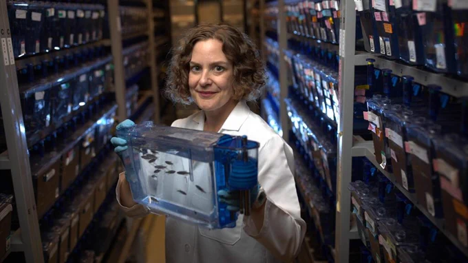 Image of Dr. Lavinia Sheets holding a fish tank.