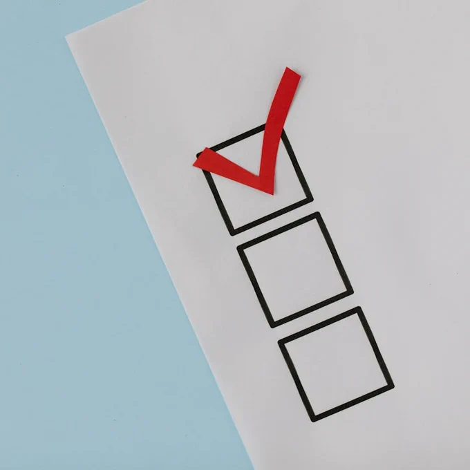 Stock image of survey paper - one box on top with red checkmark, two empty boxes (without check mark) below it.