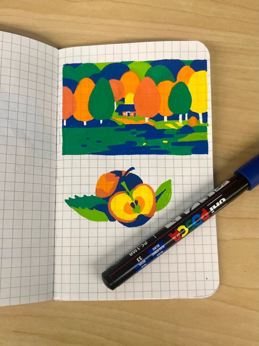 a pair of posca paint pen drawings in a gridded notebook: a small red house nestled in a fall landscape overlooking a lake and a pair of apples, one cut in half