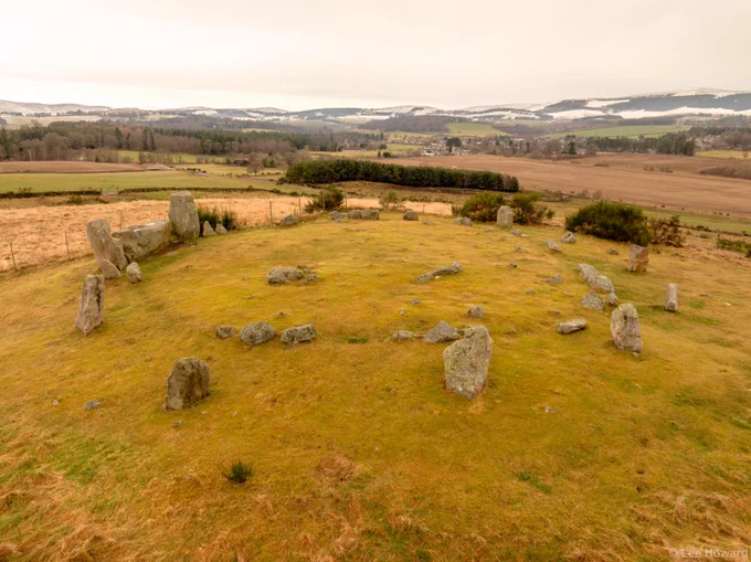 The upright stones forming the ring include a large horizontal ‘recumbent’ (flat-lying) stone in the southern quadrant and are arranged so that they reduce in height from the two flankers on the south-west round to the shortest stone in the north-north-east and the gaps between the stones also close up towards the north-east – the whole enclosing a low polygonal cairn, the perimeter of which is delimited by a now discontinuous series of kerbstones. This, in turn, is revetted by a surrounding platform of rubble, into which the standing stones are set. The recumbent, the flankers, the orthostats (upright standing stones) and the kerbstones of the internal cairn are all Granite-Granodites and the admixture in the recumbent includes a high quotient of quartz grains.3 Most of the orthostats are pink in colour, the recumbent is paler in colour due to its quartz content. The kerb and interior of the platform are predominantly pink or red. 