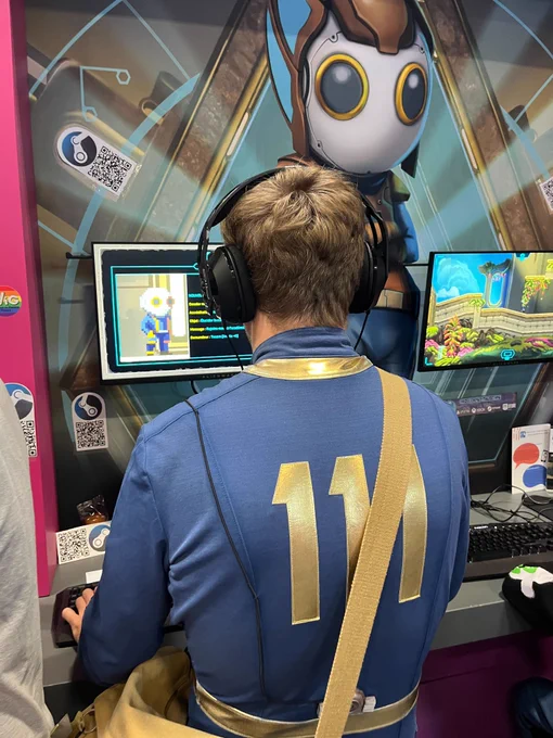 Photo of a visitor cosplaying a Vault 111 resident trying Exographer at the Jeux Made in France corner at Paris Games Week 2024.