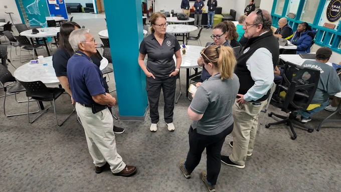 a group of people talking in a circle