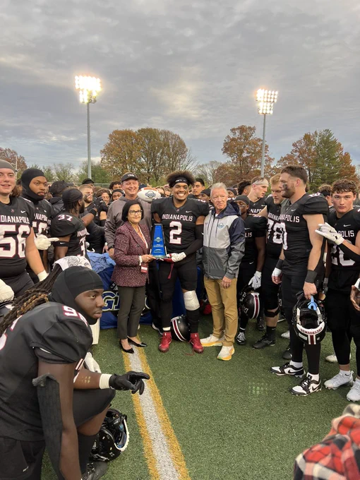 Student Athletes, Coach Keevers and President Singh with the 2024 GLVC Football Championship Trophy