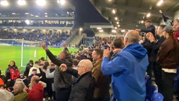 Grimsby town fans celebrating a win at Wimbledon