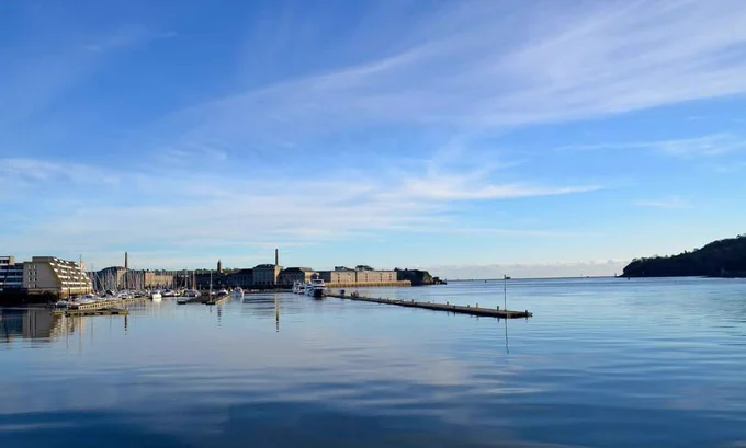 Blue skies over the Tamar Estuary,  with the Royal William Yard on the left of the estuary. 