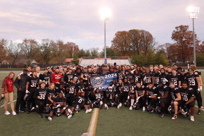 The entire UIndy football team poses with the newly-won GLVC championship trophy.