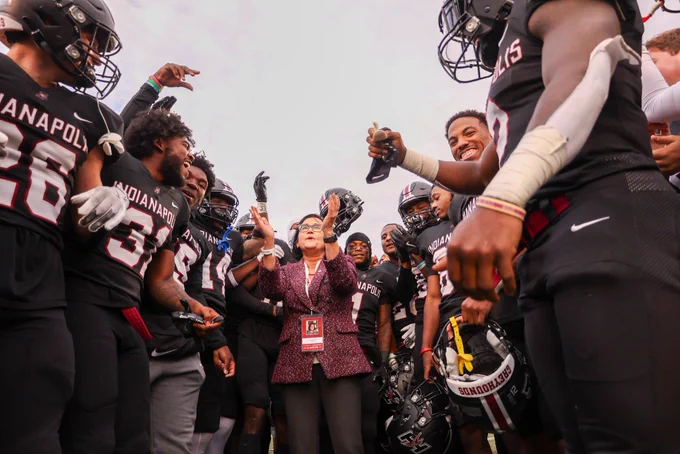UIndy president Dr. Tanuja Singh celebrates with the University’s GLVC-champion football team.