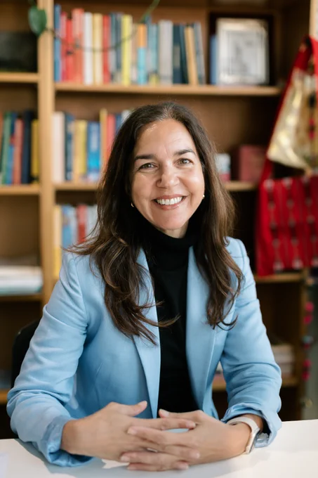 A headshot of The Hon Lisa Singh who is sitting in an office and happily smiling