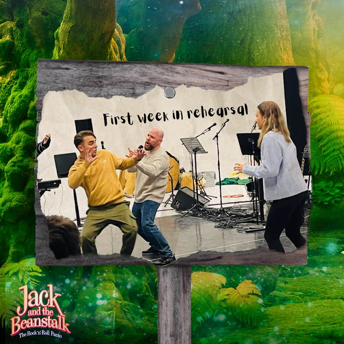 A wooden signpost in a forest where an image on paper is pinned, showing three performers acting in a rehearsal room. The image is labelled 'First week in rehearsal'. The logo for Jack and the Beanstalk: The Rock 'n' Roll Panto sits in the bottom left corner of the image