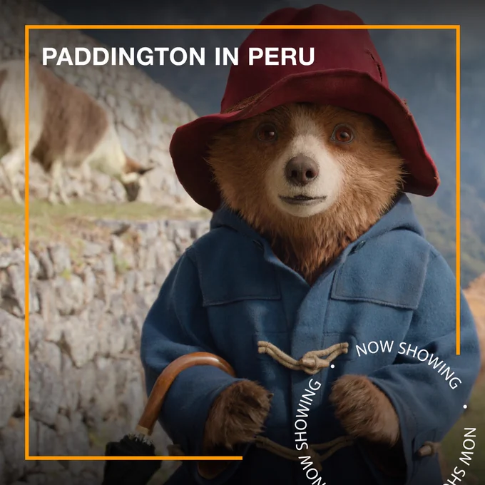 Paddington, a small brown bear wearing a blue duffle coat. Text - Paddington in Peru, Now Showing