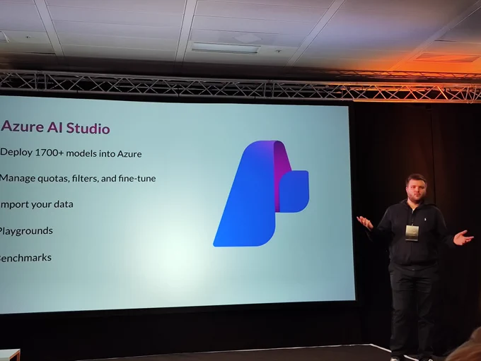 Callum talking on a stage in front of a slide on Azure AI Studio.