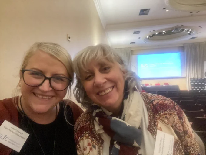 Two staff members of @wdclibraries posing with big smiles at the SLIC Showcase