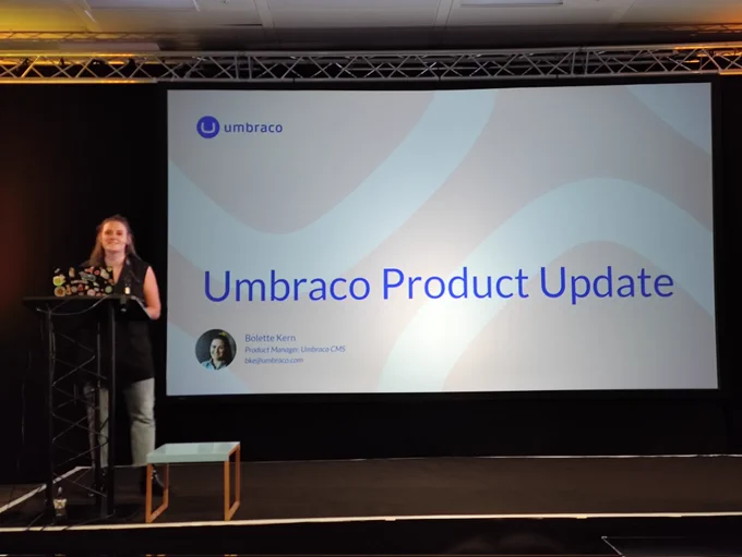 Bolette standing by a slide marked 'Umbraco Product Update'.