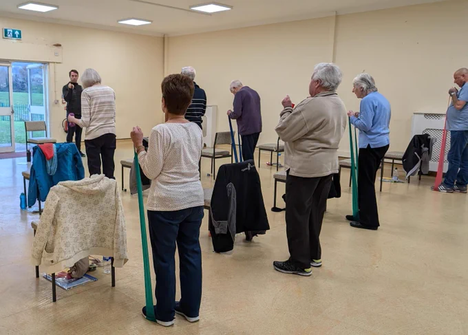 People in a community centre taking part in a pulmonary health exercise class