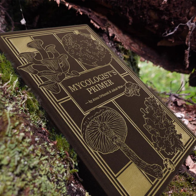 Deluxe edition of Mycologist's Primer, on a mossy log
