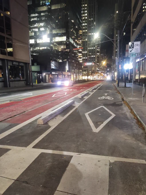 a photo of red paint dedicated streetcar lanes next to separated bike lanes 
