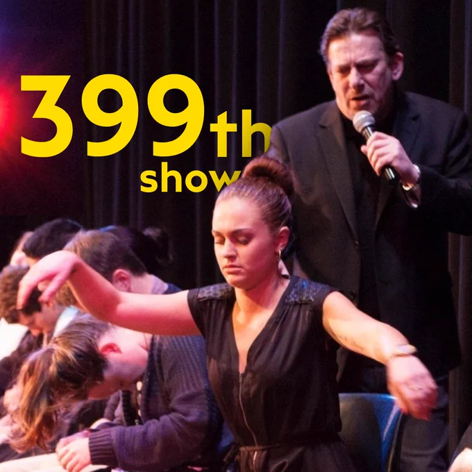 Andrew Newton hypnotises an audience member. Behind, a title reads 399th show