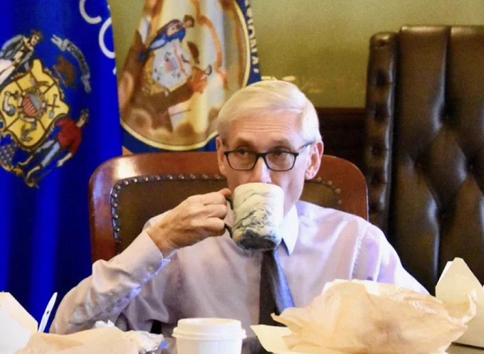 Gov. Evers sips a mug of tea.
